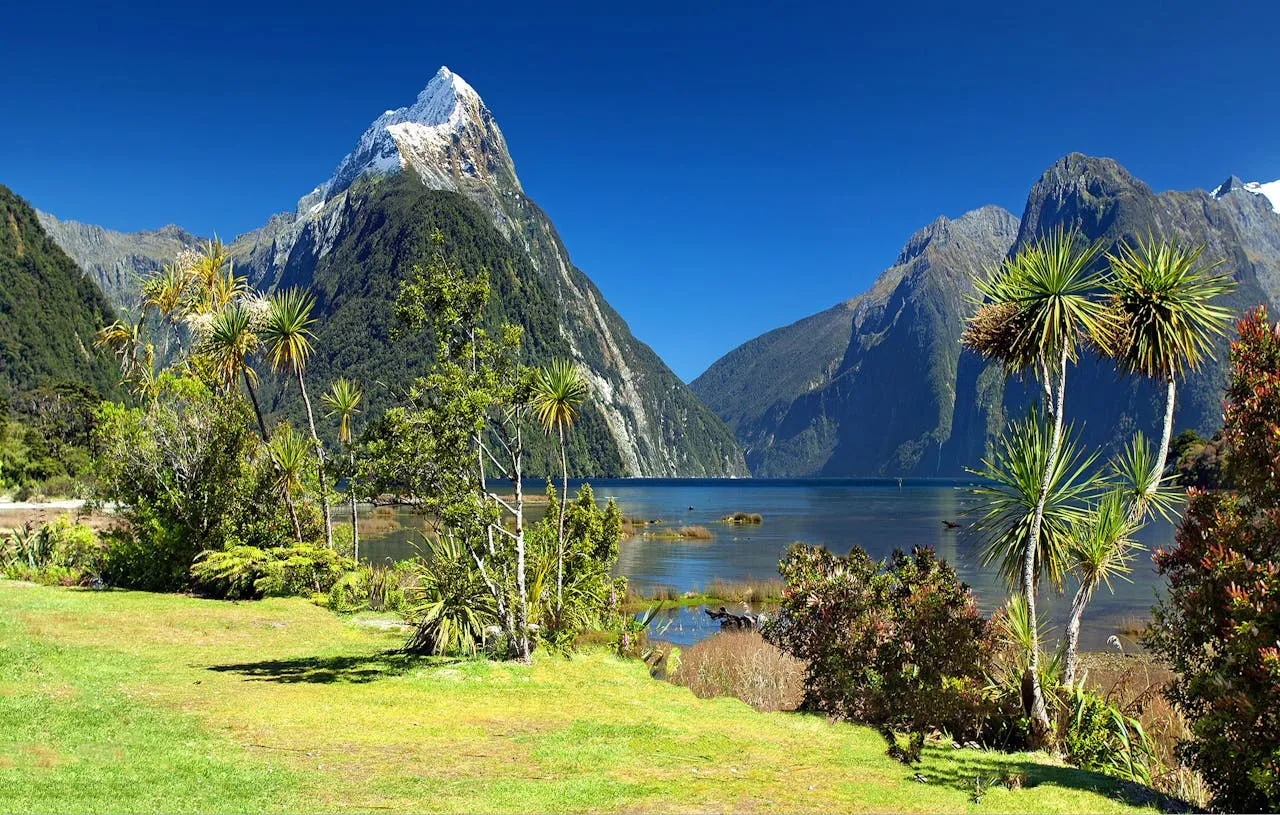 Stunning New Zealand mountain landscape with snow-capped peaks reflected in a pristine lake
